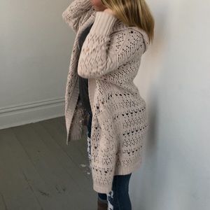 Beige knit cardigan.